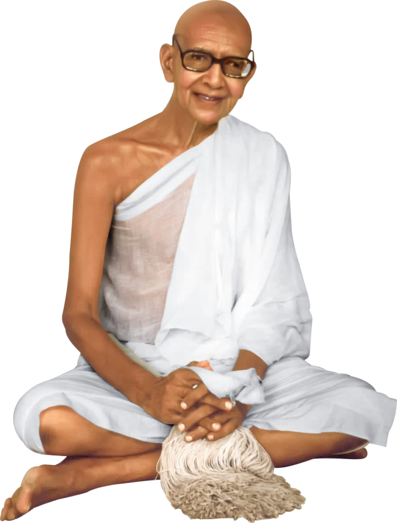 Jambuvijayji Maharaj Saheb in white robes sitting cross-legged.